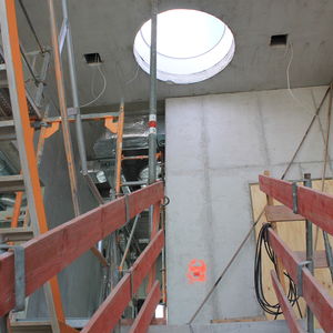 A circular roof window on the fourth level brings lots of light into the staircase.