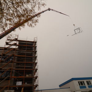 … then it was lifted by a crane to its future location. The little dab next to the “flying frame” could have been a plane – but there is no plane seen on the other photos. The photographer swears that there was absolutely no plane around at this time! The Truth is out there, somewhere