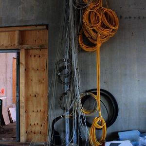 Woe to he who loses the perspective. Data- and telephone cables run like veins through the building.