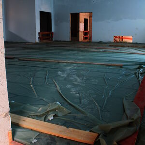 The newly laid screed in the new production hall. The height of the board shows the thickness of the screed, which is necessary to carry the heavy machinery.