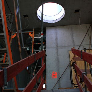 A circular roof window on the fourth level brings lots of light into the staircase.
