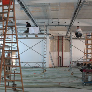 Busy men lay cables and pipes in the new machine hall.