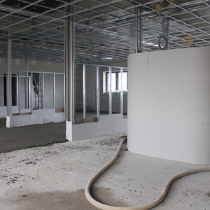 The screed is laid in the future office floor. Front row right the future cabin for printer and plotter, followed by a conference room…